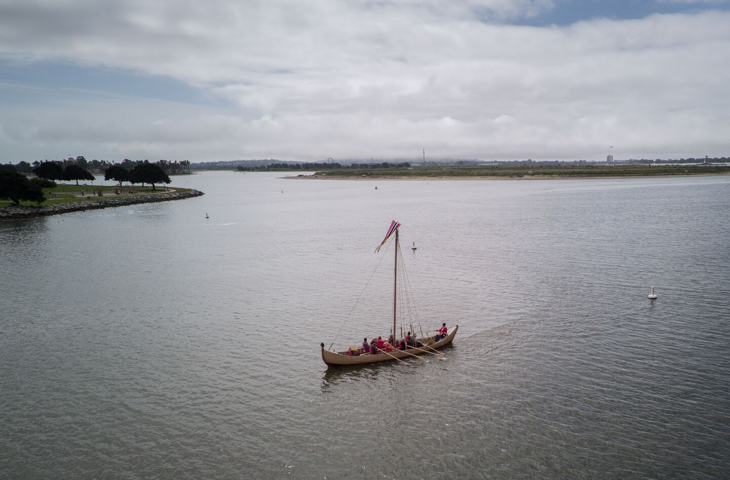 Maiden voyage of Viking ship replica Sleipnir at De Anza Cove area of Mission Bay. The ship driven by crew members using oars, makes its way across the De Anza Cove area of Mission Bay after it was lowered into the bay via the boat launching ramp.