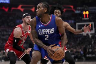 Los Angeles Clippers forward Kawhi Leonard (2) is defended by Chicago Bulls guards Alex Caruso.