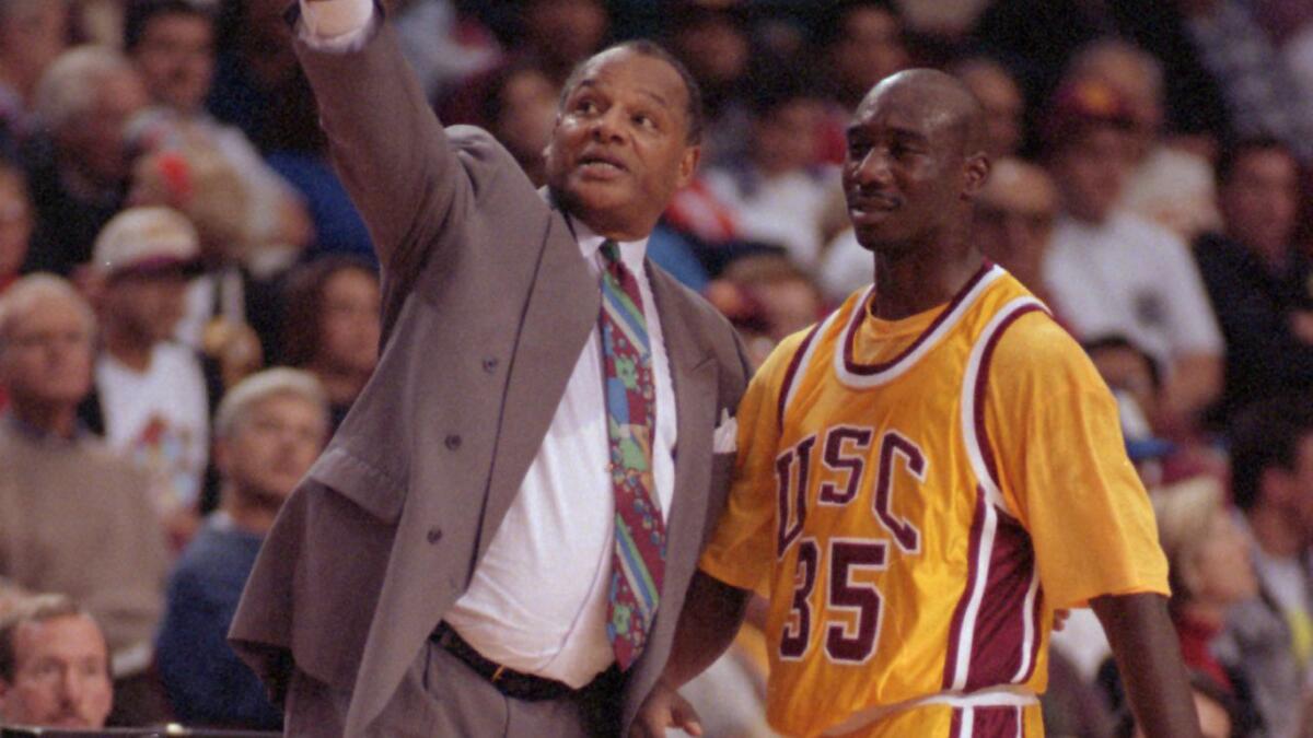 USC basketball Coach George Raveling, left, speaks with freshman Stais Boseman during a game against California in March 1994. Raveling was elected into the Basketball Hall of Fame on Saturday.