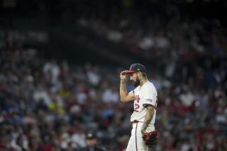 Los Angeles Angels relief pitcher Hans Crouse adjusts his hat during the sixth inning of a baseball game against the Oakland Athletics in Anaheim, Calif., Friday, July 26, 2024. (AP Photo/Eric Thayer)