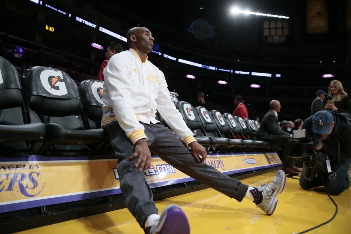 Kobe Bryant rests on the bench before a game against the Pacers at Staples Center.