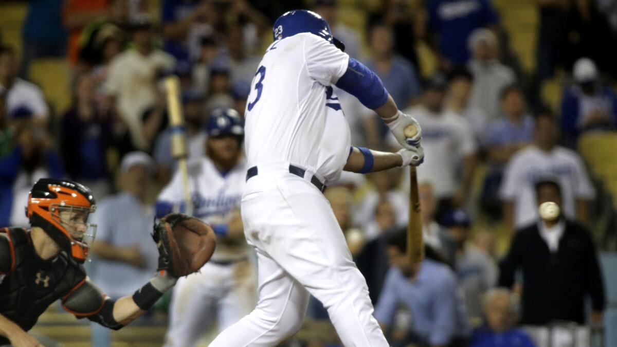 Dodgers first baseman Adrian Gonzalez connects for the game-winning hit to deep left field against the Giants in the 14th inning Monday night at Dodger Stadium.