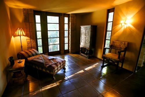 A bedroom with polished floors and open window.