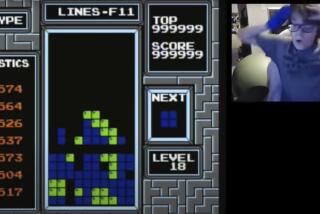 In this image taken from video, 13-year-old player named Willis Gibson reacts after playing a game of Tetris. Gibson, who in late December became the first player to officially “beat” the original Nintendo version of the game. By breaking it, of course. Technically, Gibson — aka “blue scuti” in the gaming world — made it to what gamers call a “kill screen,” a point where the Tetris code glitches, crashing the game. (Willis Gibson via AP)