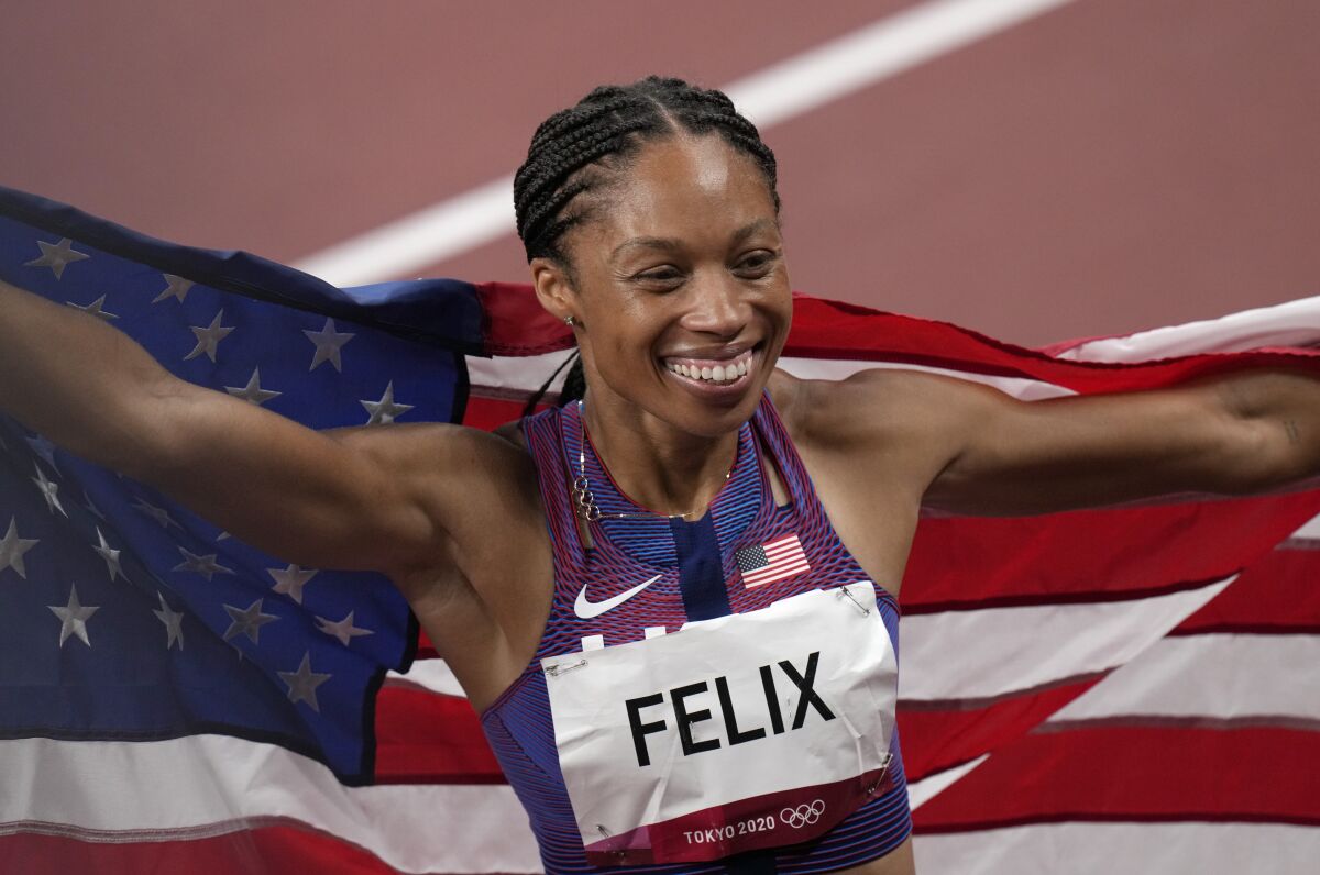 Allyson Felix, of United States smiles after taking the bronze, in the final of women's 400-meters at the 2020 Summer Olympics, Friday, Aug. 6, 2021, in Tokyo, Japan. (AP Photo/Francisco Seco)