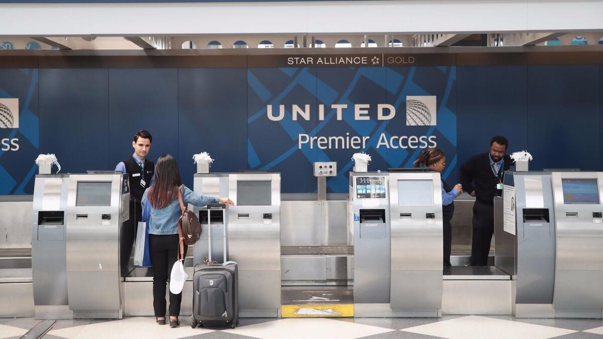 Passengers arrive for flights at the United Airlines terminal at O'Hare International Airport on Wednesday in Chicago.