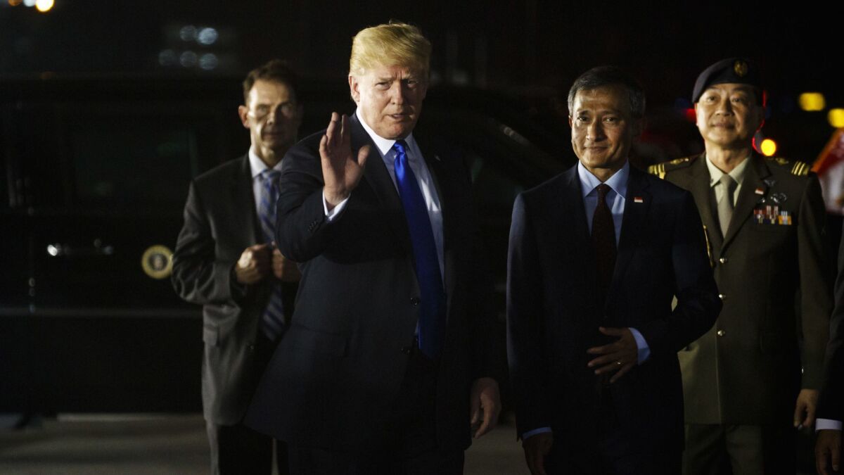 President Trump arrives at Paya Lebar Air Base for a summit with North Korean leader Kim Jong Un on Sunday in Singapore.