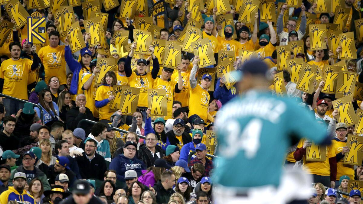 Fans in the "King's Court" cheering section hold up K cards as they cheer for Seattle Mariners starting pitcher Felix Hernandez (34) during a game against the Royals on April 29.