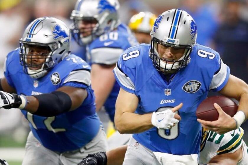 Lions quarterback Matthew Stafford, shown running against the Packers during a Jan. 1 game, wears a glove on his throwing hand that covers a splint on the dislocated tip of his middle finger.