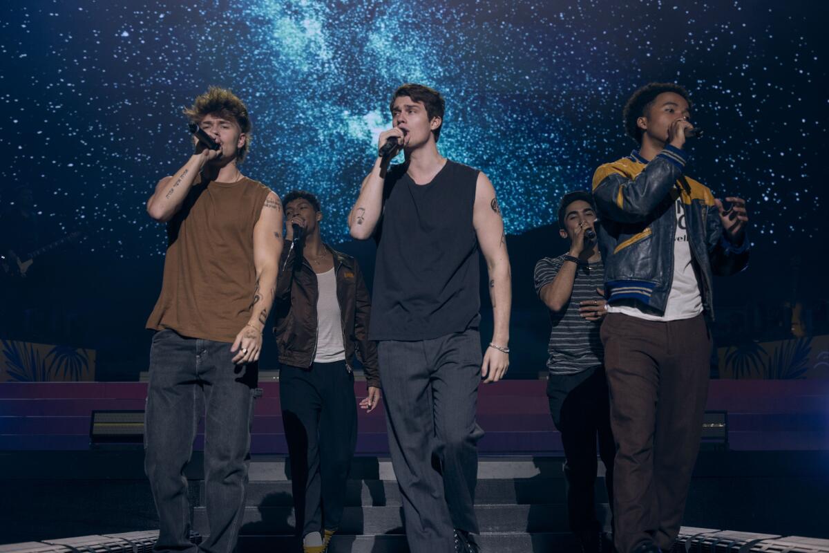 A boy band performs live.
