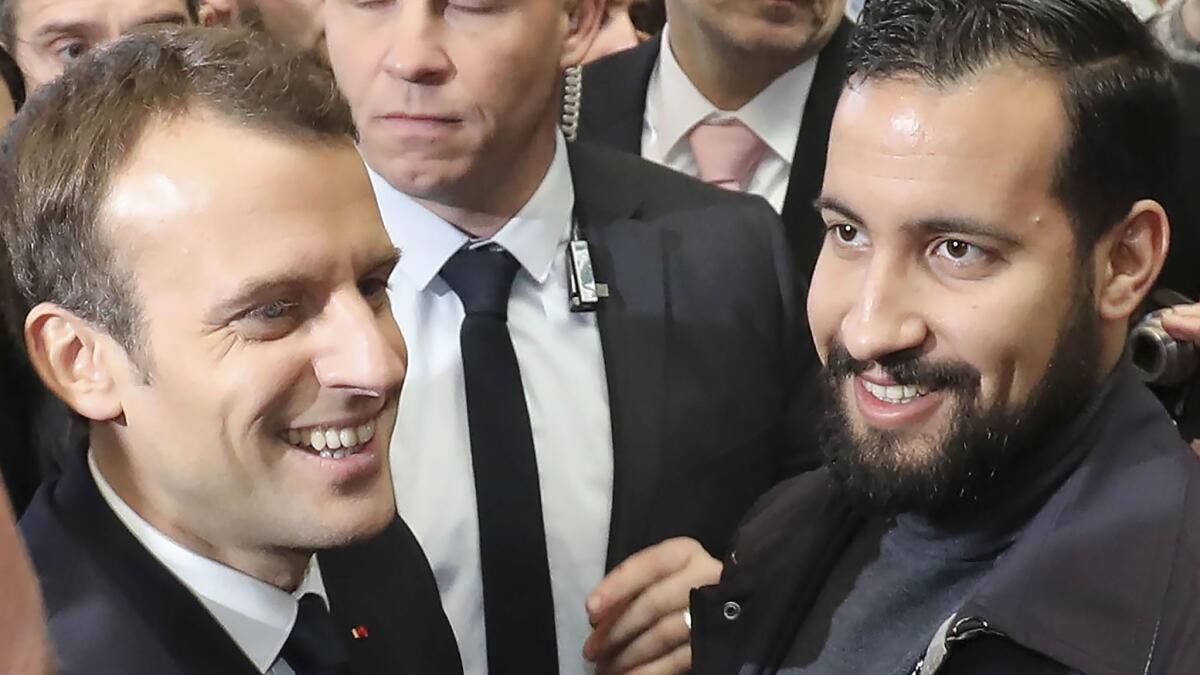 French President Emmanuel Macron with Elysee senior security officer Alexandre Benalla, right, at the Porte de Versailles exhibition center in Paris on Feb. 24, 2018.