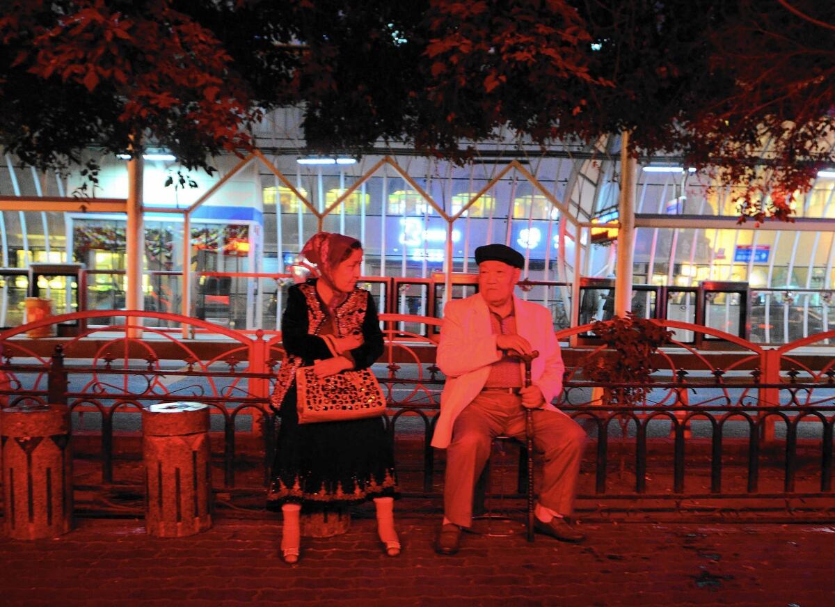 A Uighur couple relax in Urumqi, in China's Xinjiang region. Security officers often trail foreign journalists in the area, making independent reporting there difficult if not impossible.