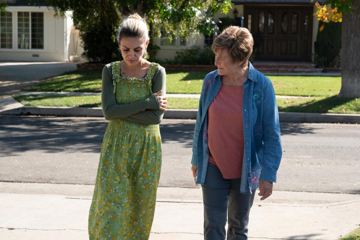 Mila Kunis, left, and Glenn Close as daughter and mother walking up a driveway in a scene from "Four Good Days" 