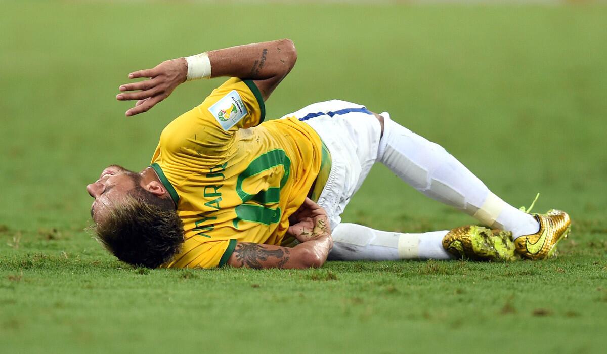 Brazil striker Neymar writhes on the pitch in pain after taking a knee to his lower back late in a World Cup quarterfinal game against Colombia on Friday at Estadio Castelao in Fortaleza, Brazil.