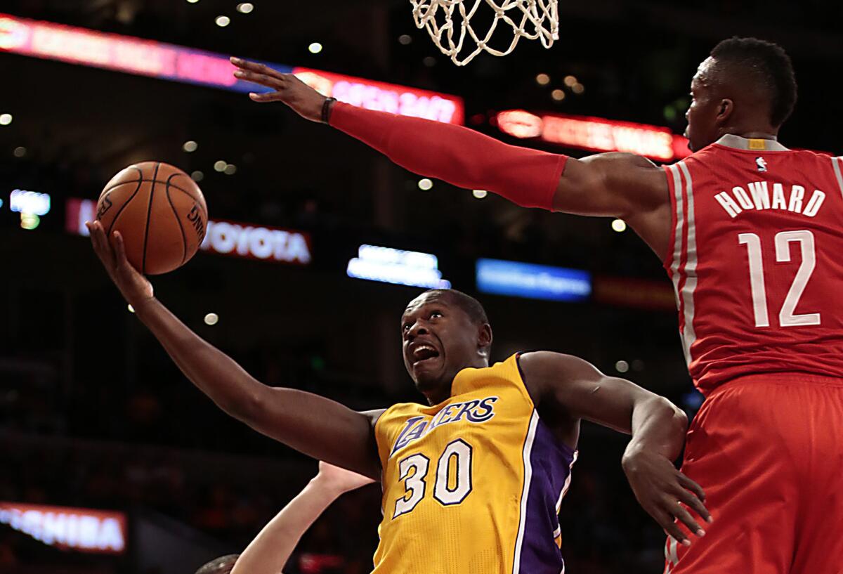 Lakers rookie forward Julius Randle goes up for a shot in the first half of the regular season opener against the Rockets.