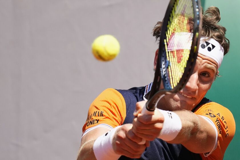 Norway's Casper Ruud plays a shot against China's Zhang Zhizhen during their third round match of the French Open tennis tournament at the Roland Garros stadium in Paris, Saturday, June 3, 2023. (AP Photo/Christophe Ena)