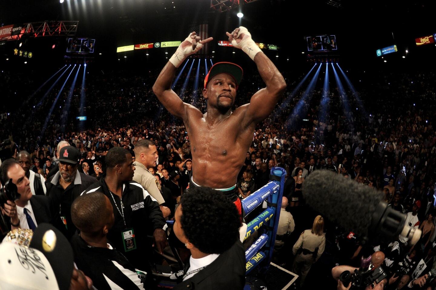 Floyd Mayweather Jr. celebrates his victory by majority decision over Marcos Maidana in a welterweight unification title bout at the MGM Garden Arena in Las Vegas.
