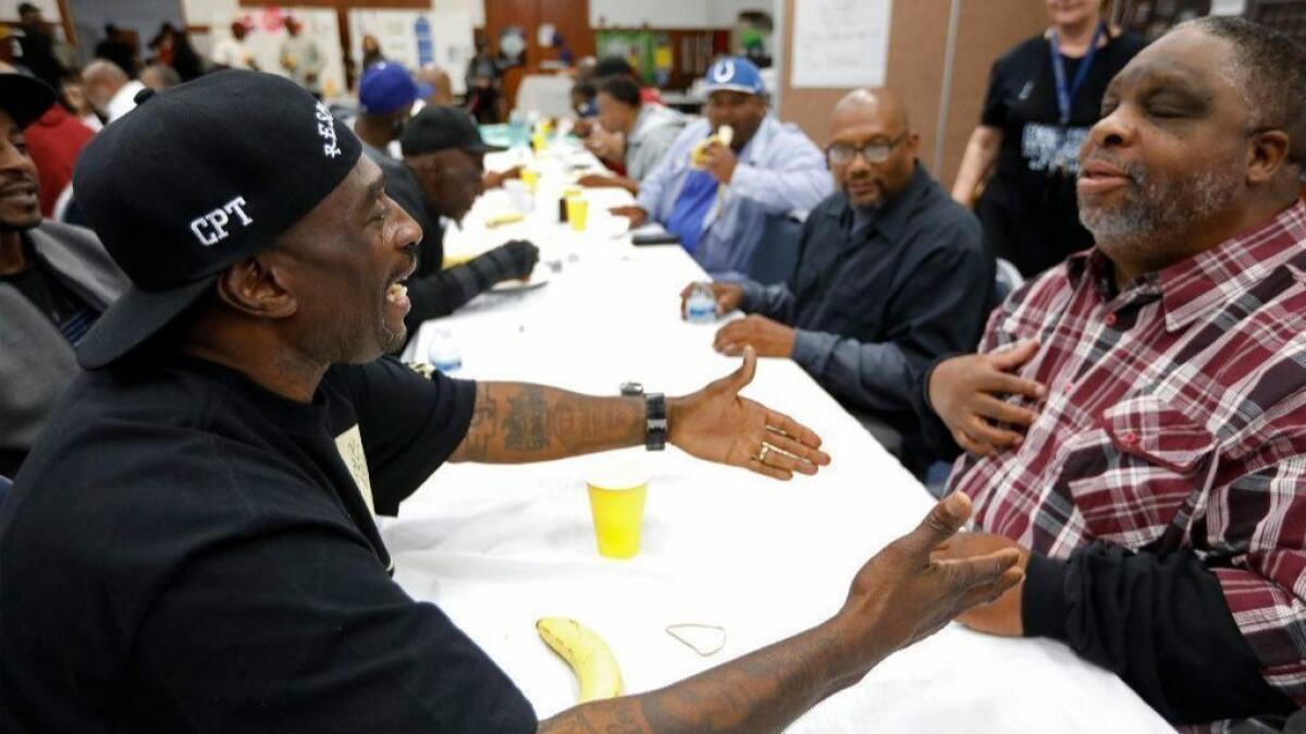 At a church in Compton, Frederick "Gangster" Staves from the Santana Blocc Crips and Donal "Donwon" Holloway from the Fruit Town Pirus talk among current and former gang members gathered to negotiate a cease-fire agreement.