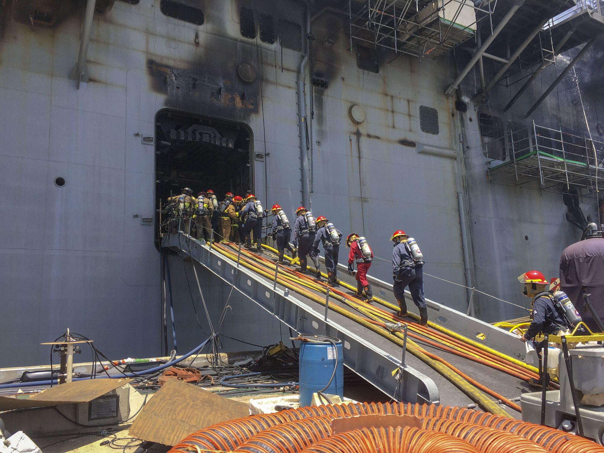 Sailors combat a fire aboard the amphibious assault ship USS Bonhomme Richard on July 13, 2020. 