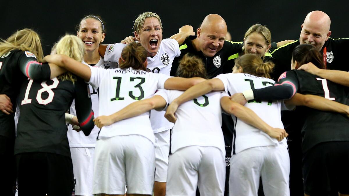 U.S. captain Abby Wambach, center, celebrates with teammates and coaches following a 2-0 win over Germany in the Women's World Cup semifinals in Montreal, Canada, on June 30.