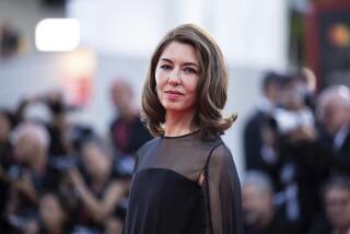 Director Sofia Coppola poses for photographers in black gown