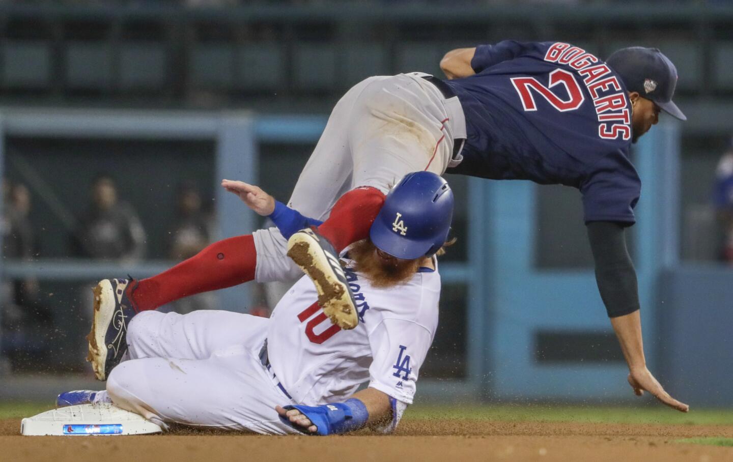 Dodgers Justin Turner is out at second on an eighth inning Max Muncy grounder as Red Sox shortstop Xander Boegaerts tumbles over him.