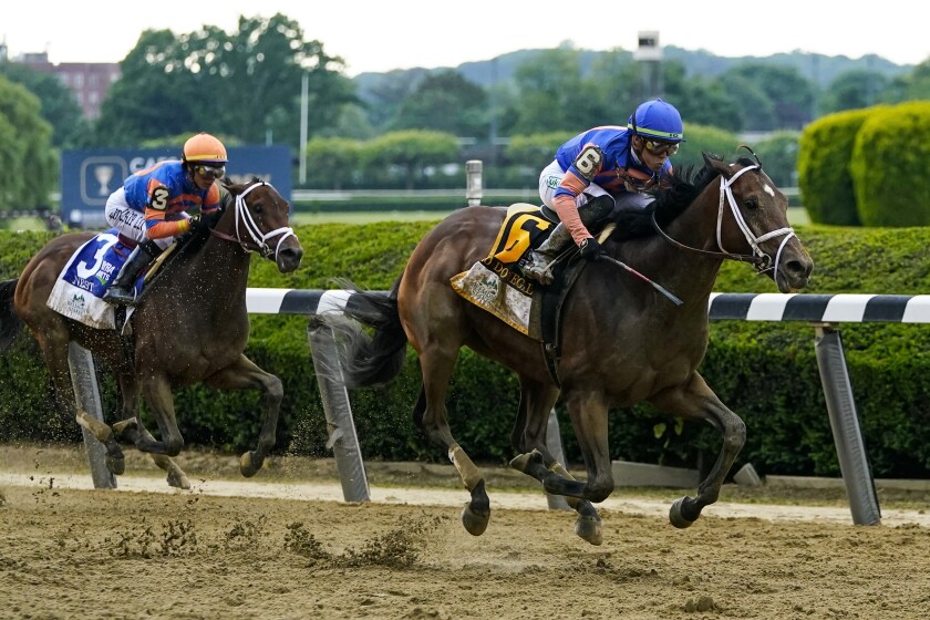 Mo Donegal, right, pulls away from Nest to win the Belmont Stakes on Saturday.