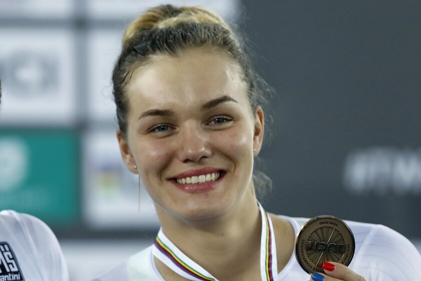 FILE - Russian track cyclist Anastasiia Voinova holds her third place medal in the women's 500m time trial at the World Track Cycling championships in Hong Kong, Saturday, April 15, 2017. Voinova and Mariya Novolodskaya who won medals at the Tokyo Olympics have been ruled ineligible to race for beaching rules monitoring their neutrality during the war on Ukraine. (AP Photo/Kin Cheung, File)