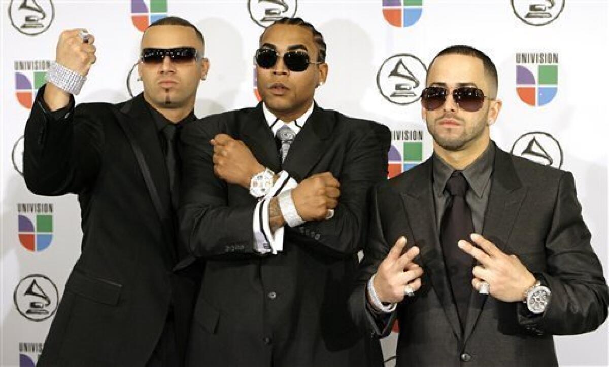 FILE - In this Nov. 2, 2006 file photo, Yandel, left, Don Omar, center and Wisin arrive for the Latin Grammy Awards in New York. The popular Puerto Rican reggaeton duo of Wisin and Yandel is breaking up. Accompanied by Yandel, reggaeton singer Don Omar made the announcement late Friday, May 3, 2013 at a concert in the U.S. territory as he praised Yandel's future as a soloist. Yandel's real name is Llandel Veguilla Malave, and his singing partner is Juan Luis Morera Luna. (AP Photo/Stuart Ramson