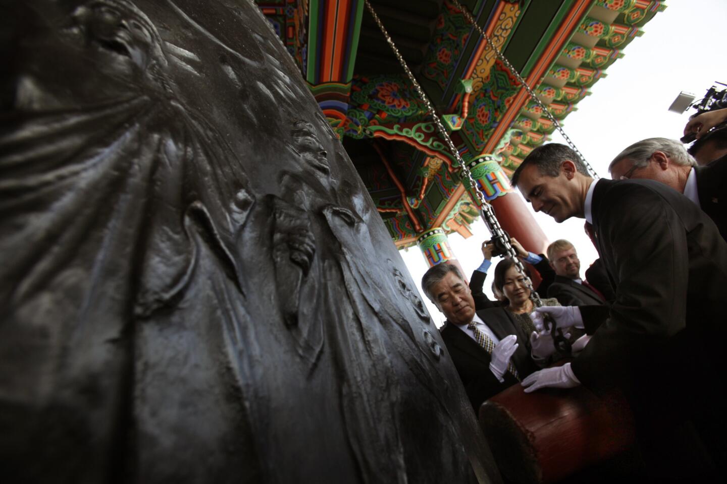 Los Angeles Mayor Eric Garcetti joins South Korean and American officials in ringing the massive bronze Korean Friendship Bell at a rededication ceremony Friday in San Pedro.