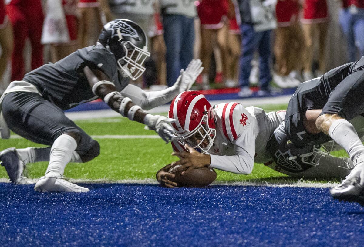 Mater Dei quarterback Bryce Young scores during the first quarter against St. John Bosco on Friday in Bellflower.