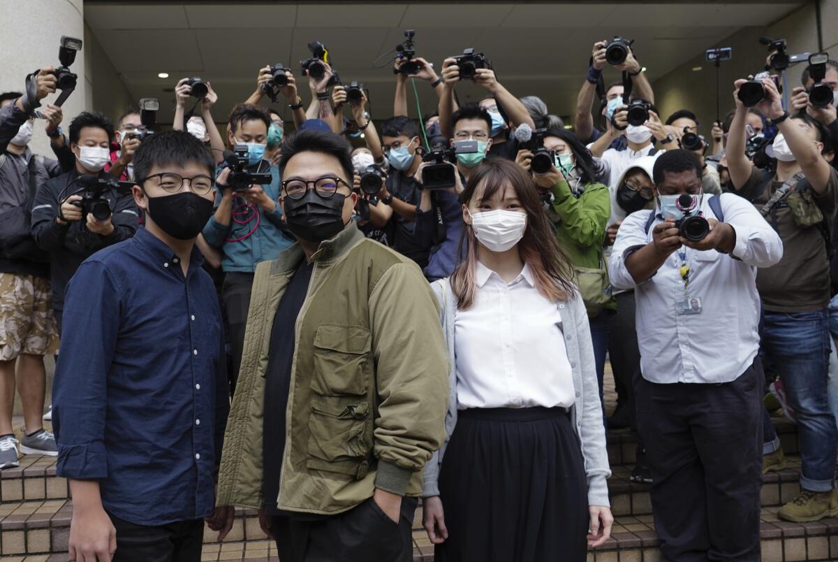 Hong Kong activists, from left, Joshua Wong, Ivan Lam and Agnes Chow arrive at court on Nov. 22.