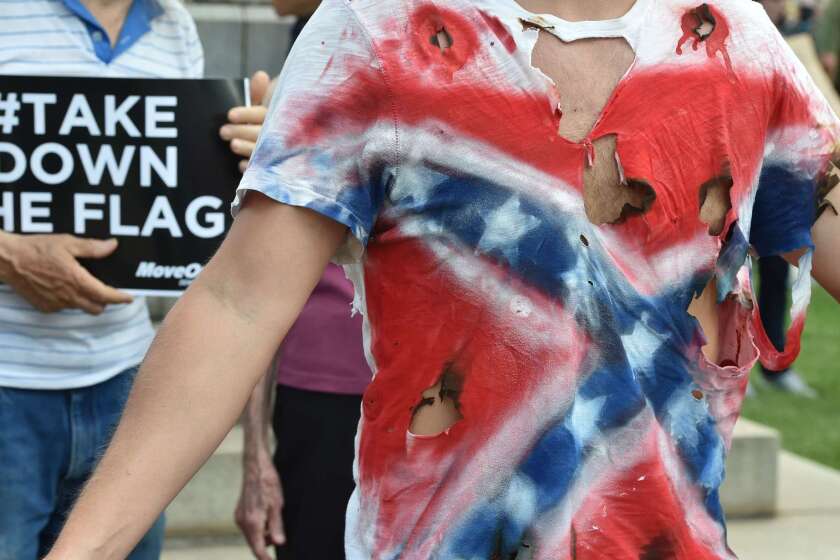 A man wears a T-shirt representing the Confederate flag during a protest in Columbia, S.C., on Saturday.