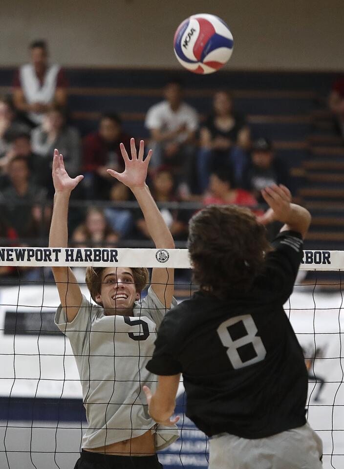 North's Cole Pender (Newport Harbor) attempts to block a shot by South's Sam Burgi (Laguna Beach) during the Dave Mohs Memorial 41st Orange County High School Volleyball All-Star boys' match on Friday, June 1.