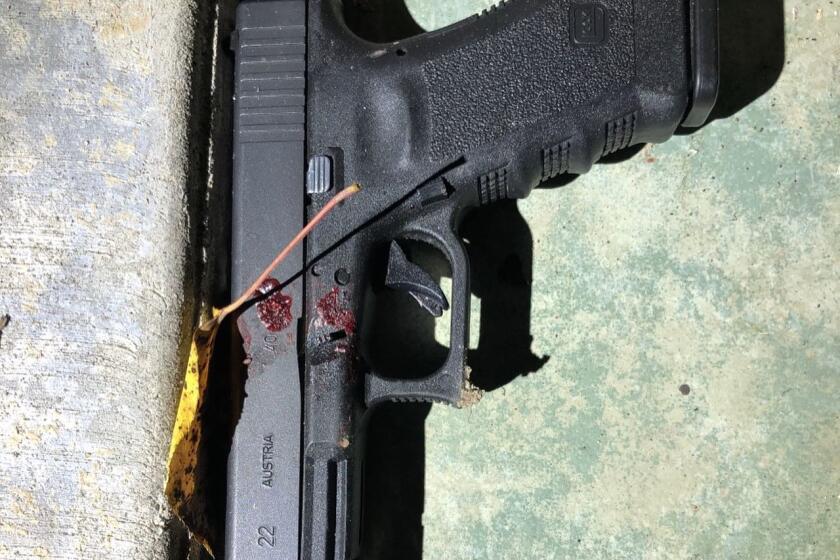 This handgun was found near a man shot and killed by Seal Beach police Monday.