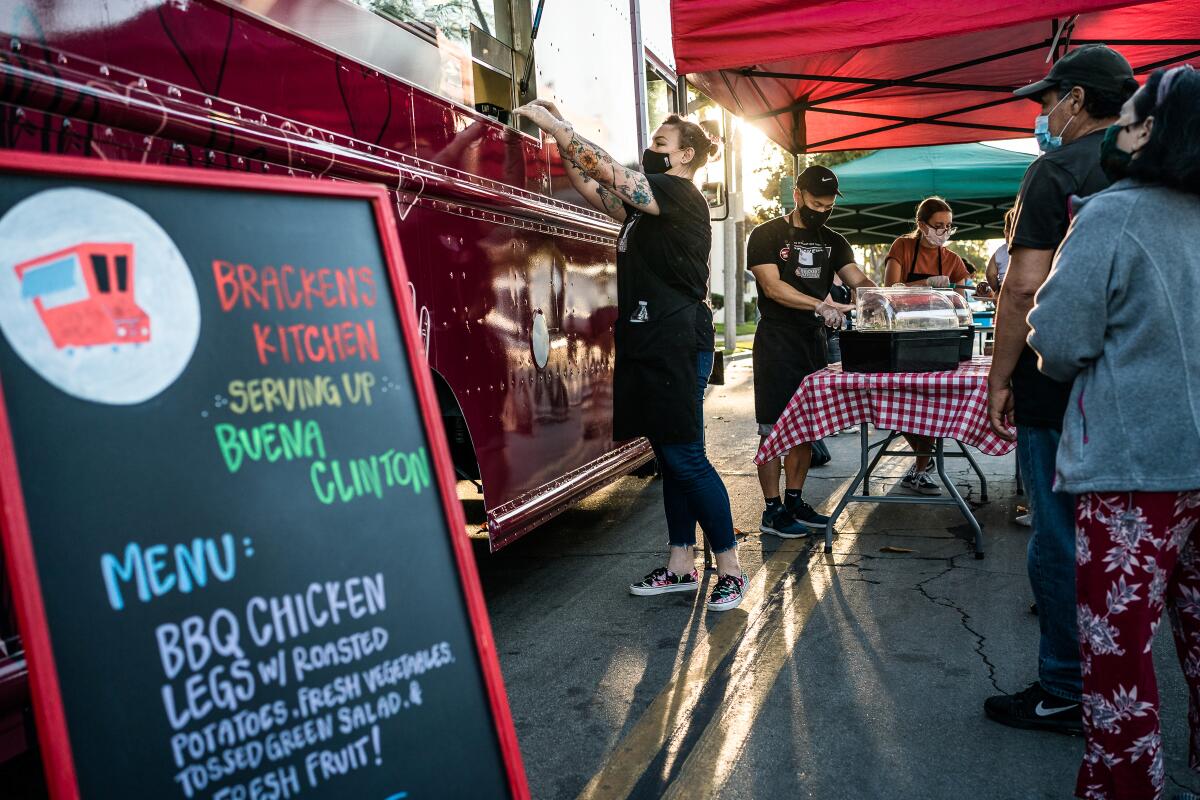 Volunteers serve the community from one of Bracken's Kitchen's food trucks.