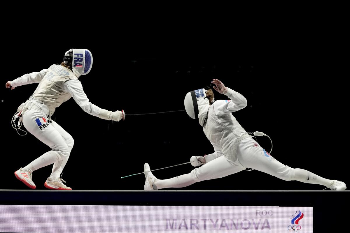 Marta Martyanova of Russia and Astrid Guyard of France compete in fencing at the Tokyo Olympics.