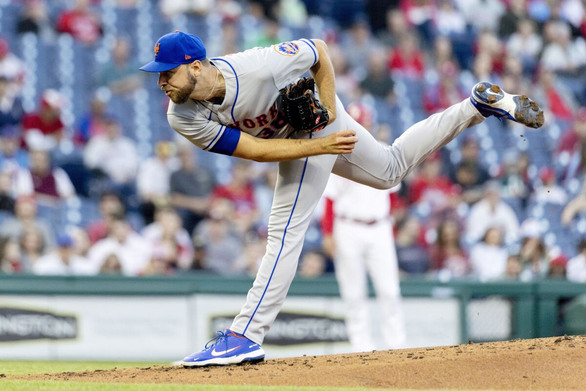 New York Mets starting pitcher Tylor Megill (38) throws during the first inning of a baseball game against the Philadelphia Phillies, Tuesday, April 12, 2022, in Philadelphia. (AP Photo/Laurence Kesterson)