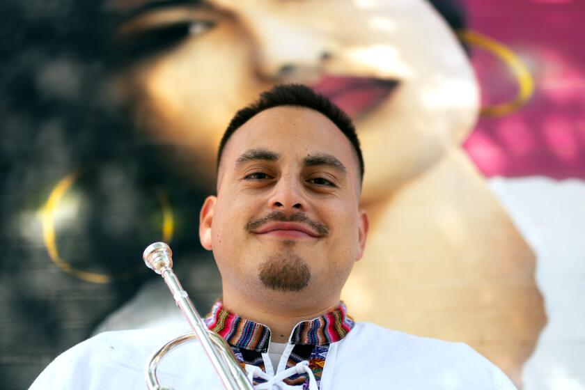 Daniel Flores poses at a Selena Tribute mural in Chicago, Ill., on Sunday, July 9, 2023.