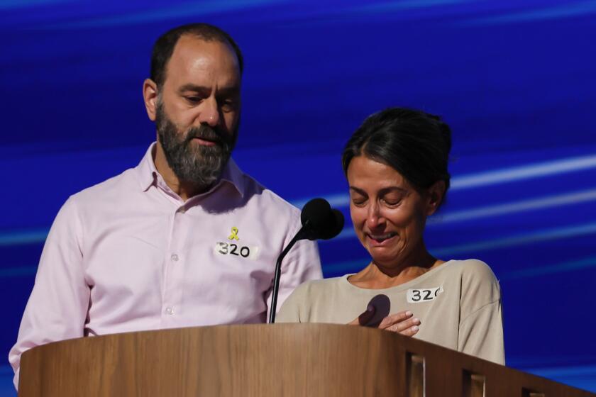 Chicago, Ill, Wednesday, August 21, 2024 - Jon Polin comforts Rachel Goldberg as she breaks down while talking about their son, Hersh Goldberg-Polin, an American-Israeli hostage who had been held in the Gaza Strip after being abducted by Hamas. They are speaking at the Democratic National Convention at the United Center.(Robert Gauthier/Los Angeles Times)