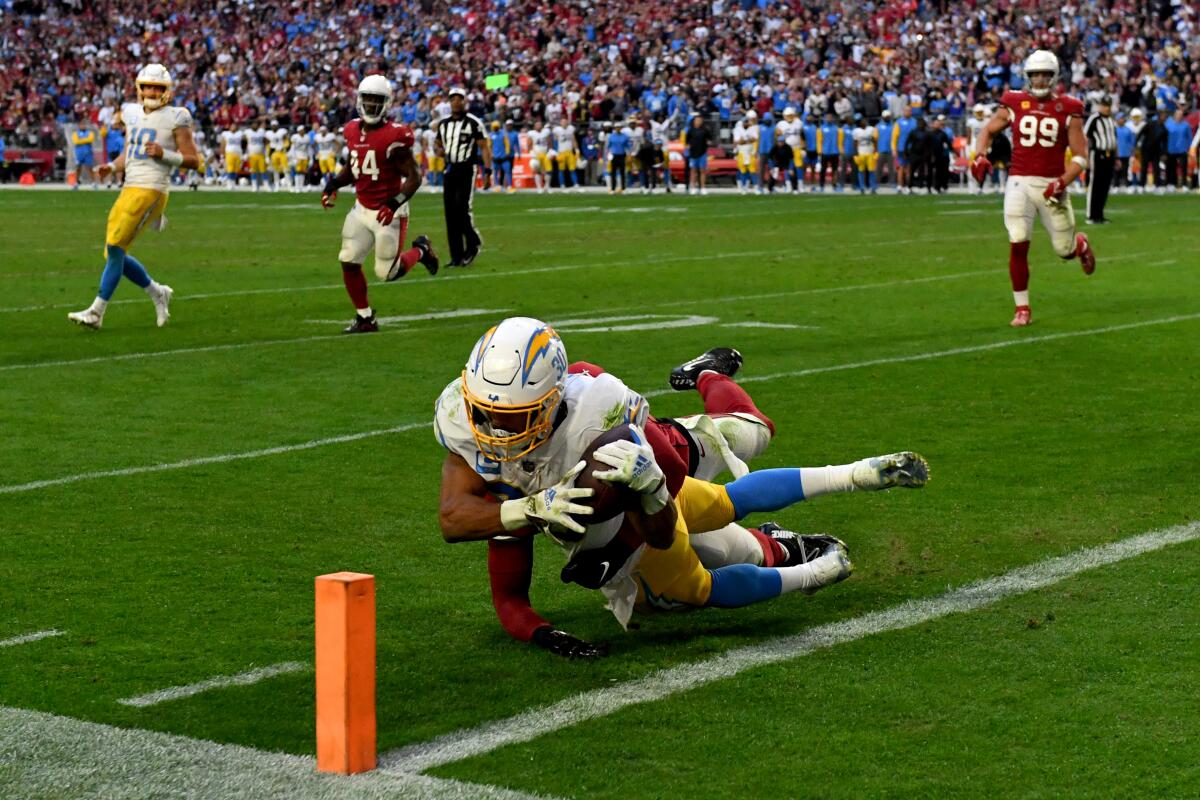 The Chargers' Austin Ekeler stretches for a touchdown that led to winning two-point conversion against Arizona.

