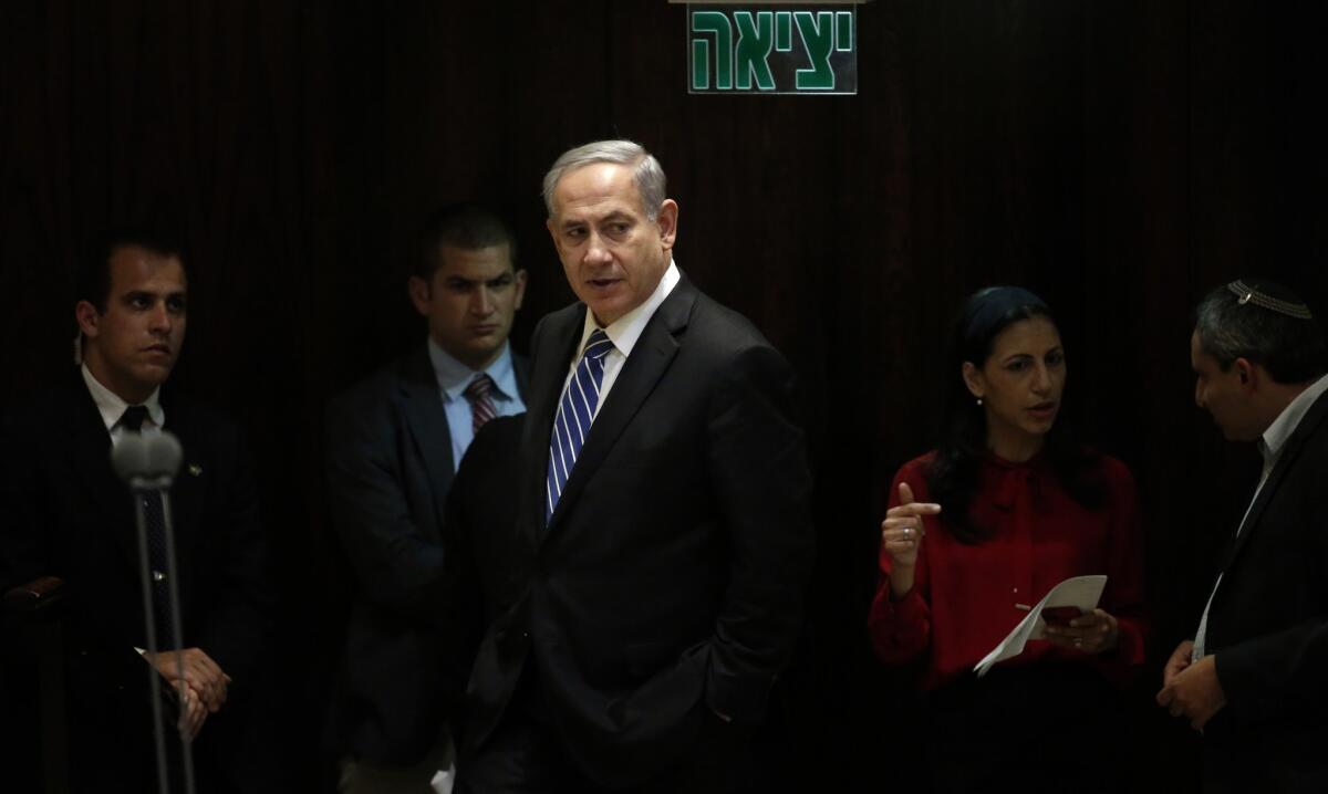 Israeli Prime Minister Benjamin Netanyahu walks to his seat before the vote to dissolve the parliament Monday.