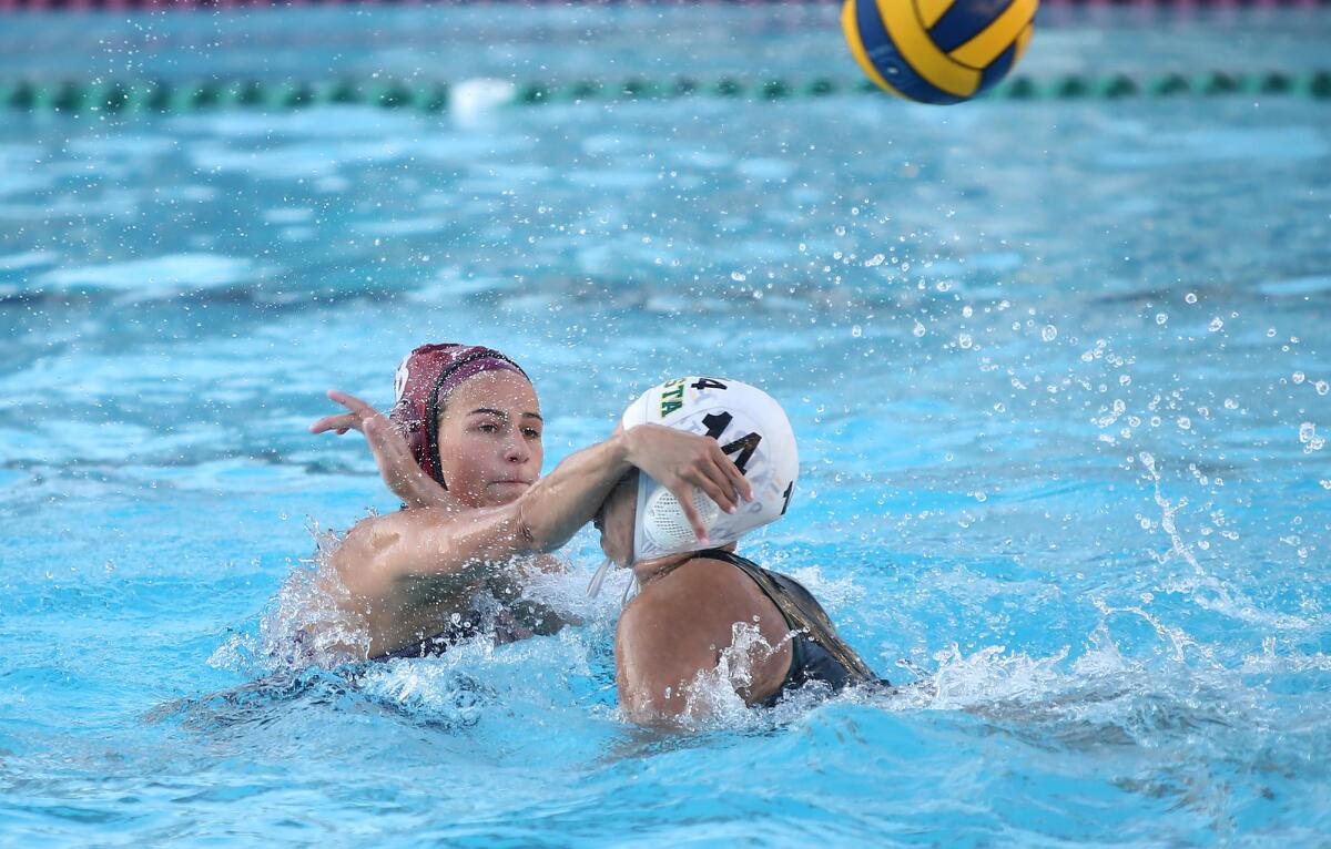 Jessie Rose (8) of Laguna Beach shoots over Mira Costa’s Izabel Smid during a nonleague water polo match on Feb. 7, 2020.