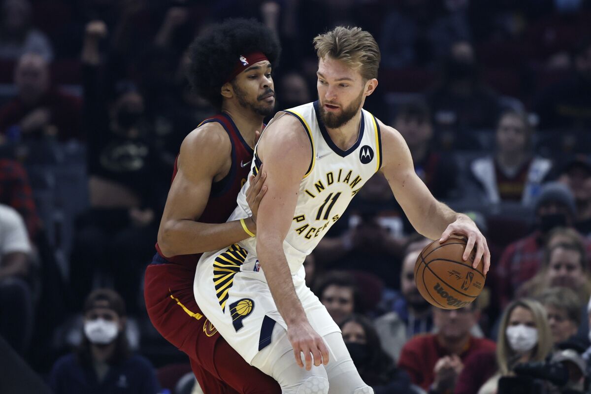 Indiana Pacers' Domantas Sabonis (11) plays against Cleveland Cavaliers' Jarrett Allen, left, during the first half of an NBA basketball game, Sunday, Feb 6, 2022, in Cleveland. (AP Photo/Ron Schwane)
