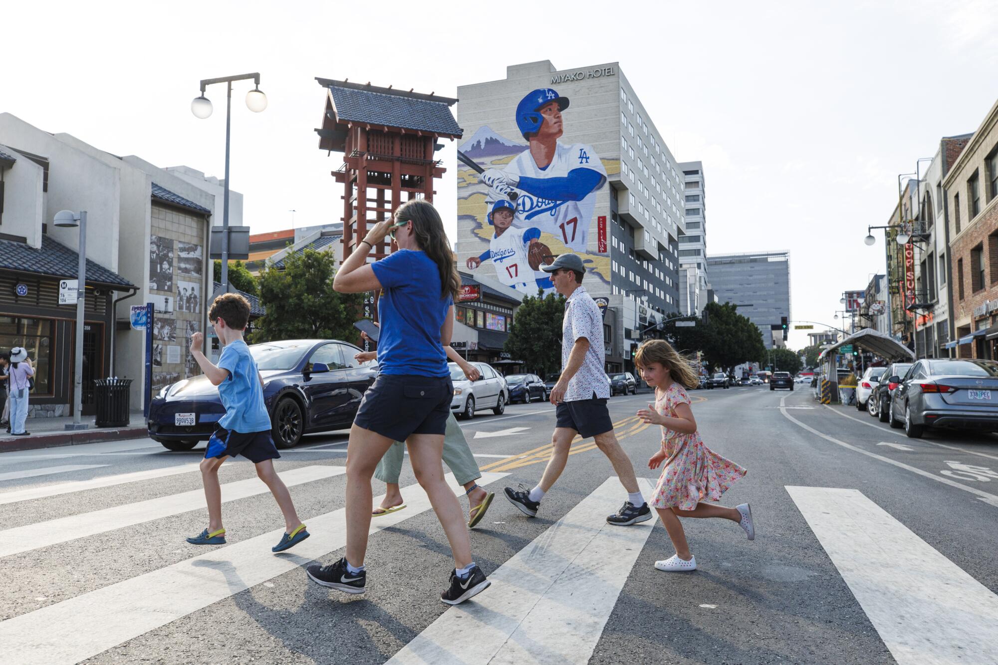 A family walks across the street in Little Tokyo. 