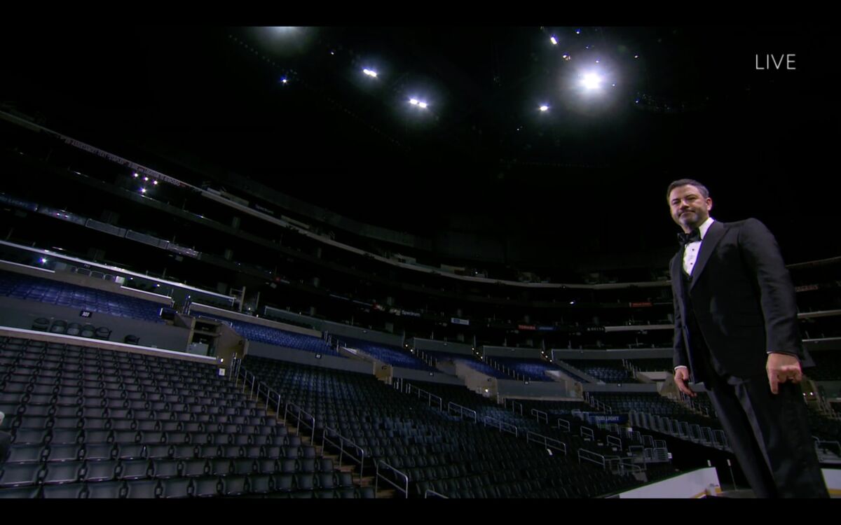 Jimmy Kimmel stands before empty seats at Staples Center.