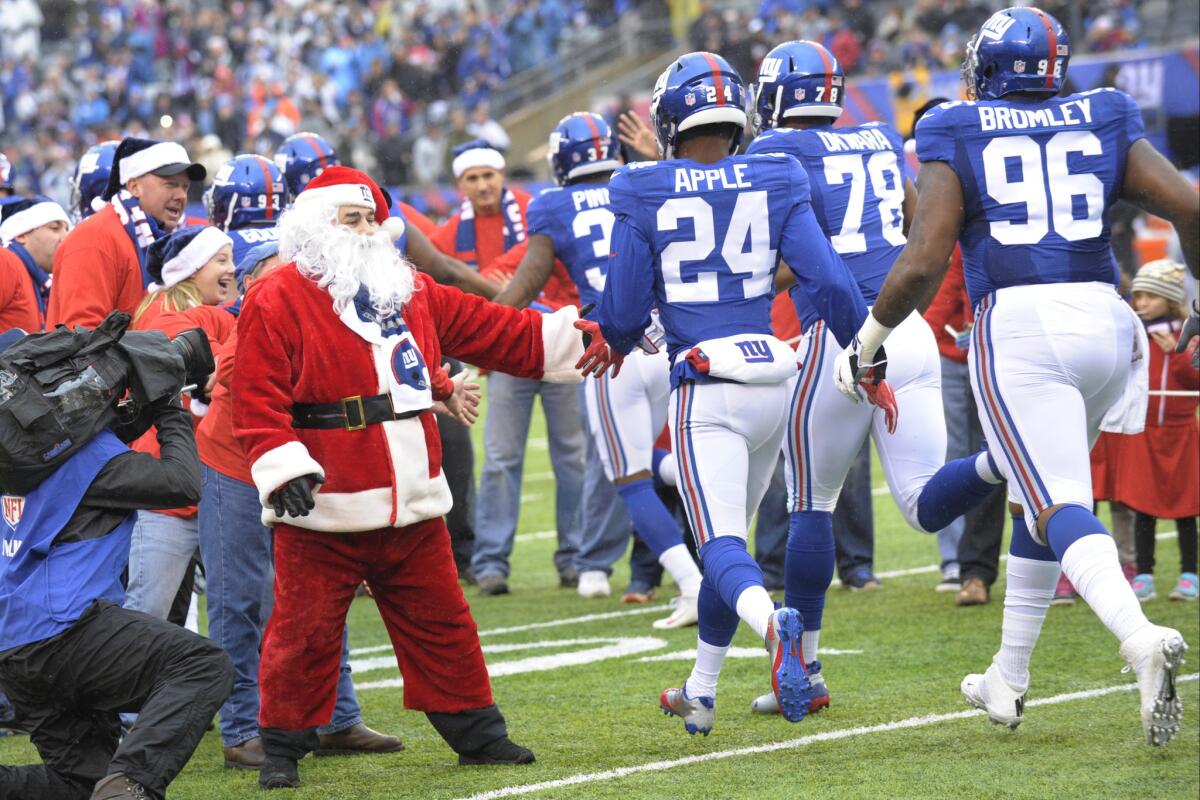 Santa Claus greets New York Giants players before their game against Detroit on Dec. 18.