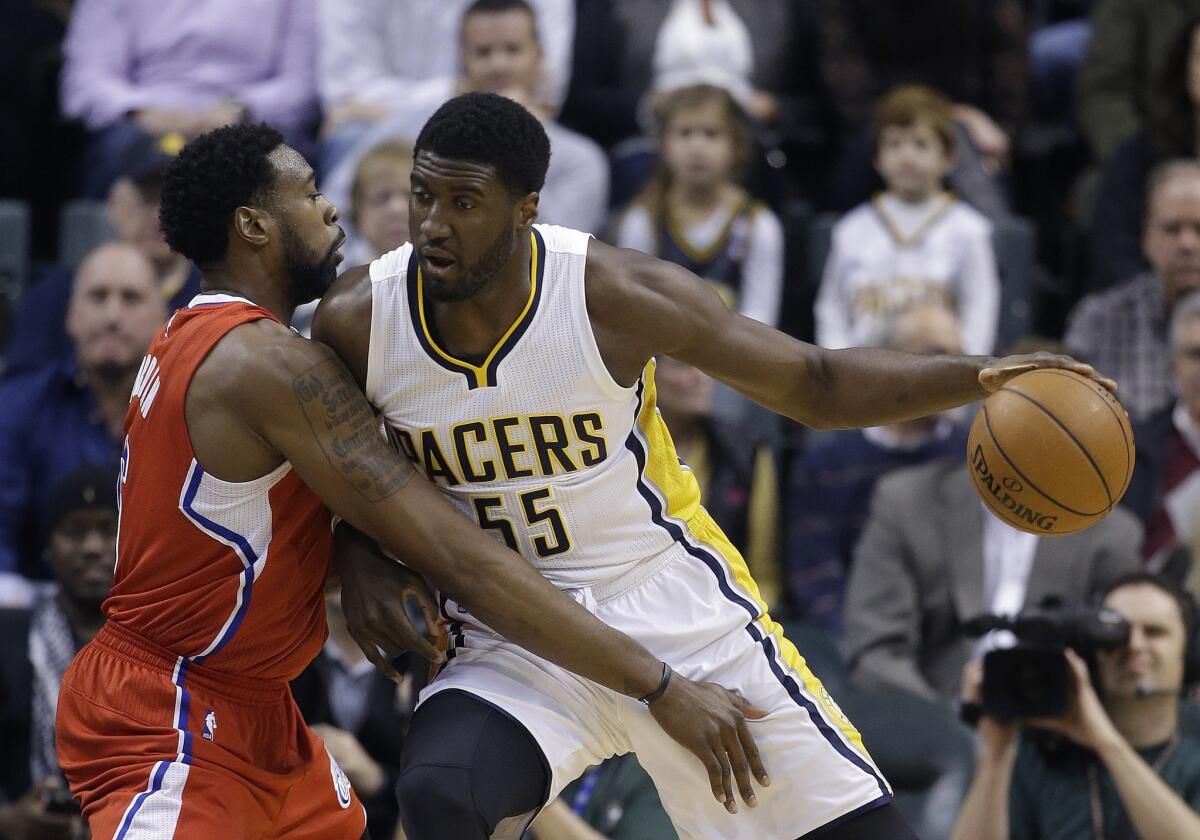 Clippers center DeAndre Jordan tries to hold his ground against Indiana center Roy Hibbert during a Dec. 10 game in Indianapolis.