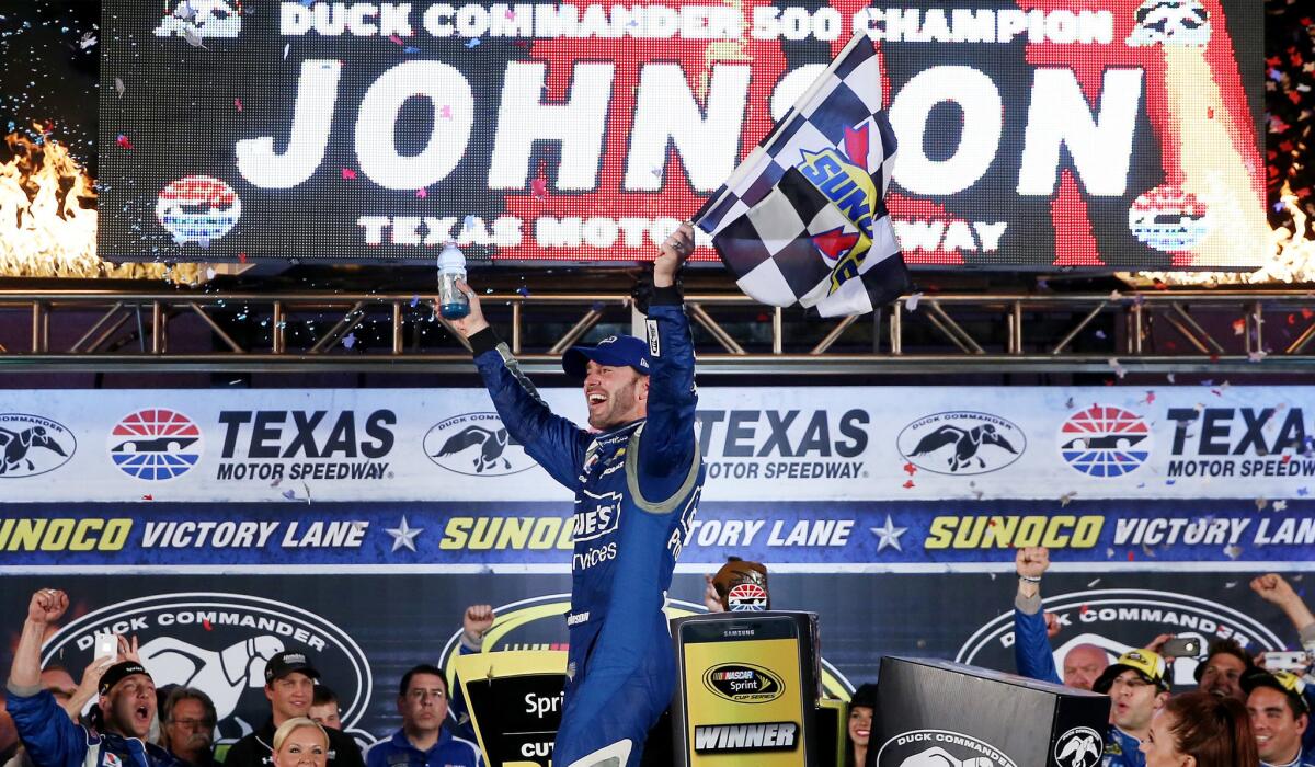 Jimmie Johnson celebrates in Victory Lane after winning the NASCAR Sprint Cup Series Duck Commander 500 at Texas Motor Speedway on Saturday night.