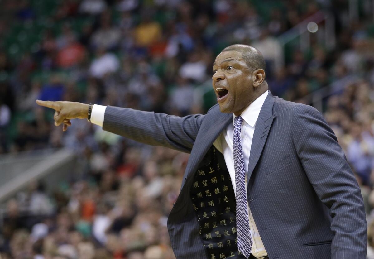 Clippers Coach Doc Rivers shouts to his team during Monday's preseason game against Utah.